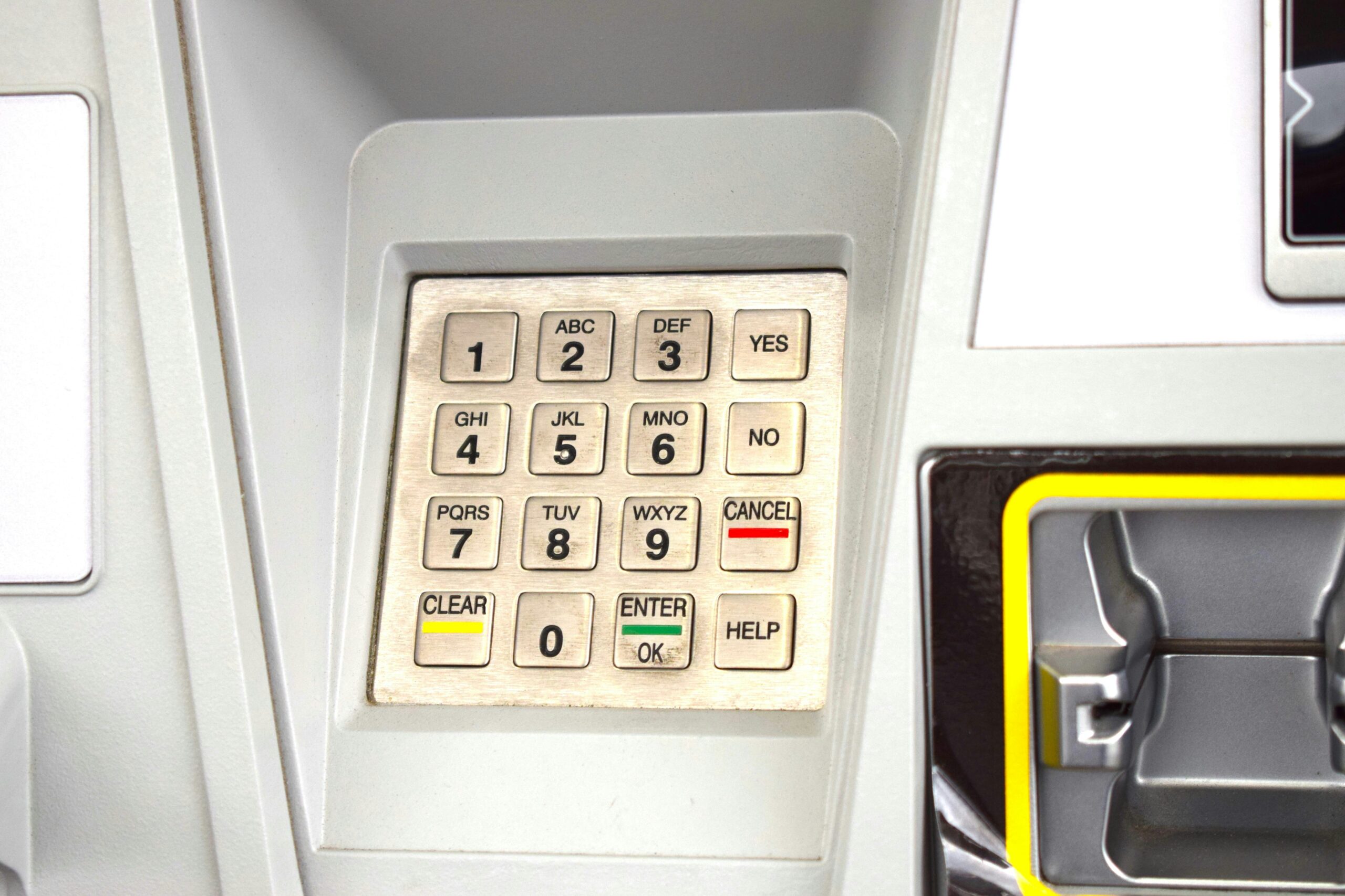 Close-up of ATM keypad with number pad, cancel, clear, enter, and help buttons